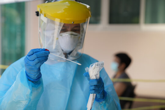 The doctors in the PPE protective suit performed a nasal congestion swab covid from a person to test for the coronavirus covid-19 infection.