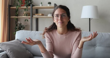 Web camera view excited young pretty businesswoman in eyeglasses taking part in virtual conference application. Happy woman blogger looking at camera, recording educational video online stream.