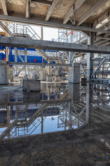 Large puddles after heavy rain on the oil refining complex under construction