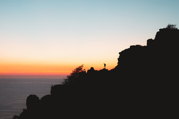 Lonely hiker silhouette during sunset in Jaizkibel, Basque Country