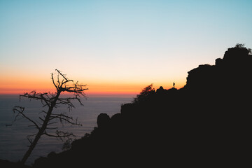 Fototapeta na wymiar Lonely hiker silhouette during sunset in Jaizkibel, Basque Country