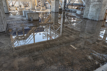 Large puddles after heavy rain on the oil refining complex under construction
