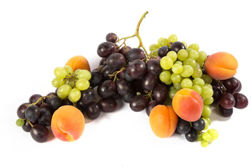 Orange apricots, black and green grapes on a white background.