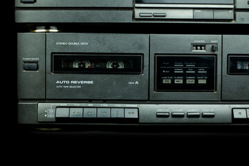 Close up front a deck recorder of the vintage stereo cassette tape player with the push operation buttons are retro technology