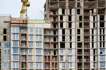 The construction of a residential building. Fragment of the facade of a house under construction. Construction fence