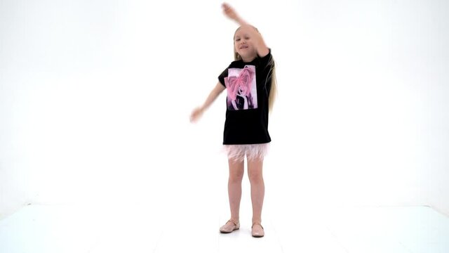 A cheerful little girl is dancing.The concept of a school of dan