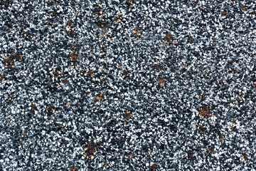 Close-up - gray-brown stone wall in the old facade of the house