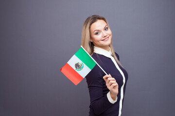 Immigration and the study of foreign languages, concept. A young smiling woman with a Mexico flag...