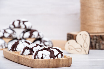 Marble chocolate cookies on a wooden stand in powder