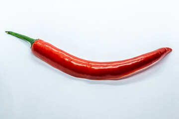 a big red chilli in white background, Selective focus, Selective focus on subject, background blur