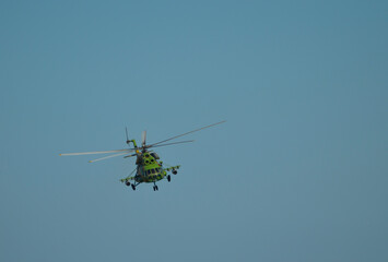 Military helicopter in blue sky, space transport photo