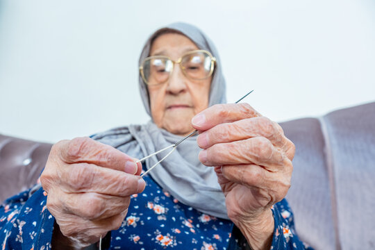 Arabic Muslim Old Woman Inserting Thread In Needle