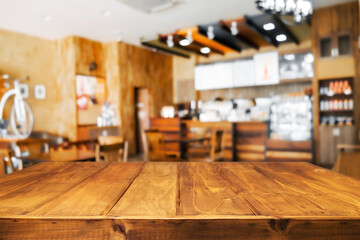 Empty wooden desk space and blurry background of restaurant vintage tone for product display montage