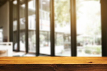 Fototapeta premium Empty wooden desk space and blurry background of restaurant vintage tone for product display montage