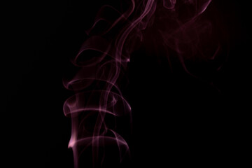 A realistic shot of a wisp of smoke against a black background - great for a cool background