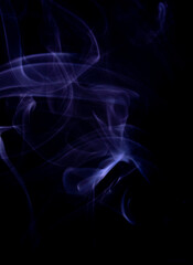 A realistic shot of a wisp of purple smoke against a black background - great for a cool background