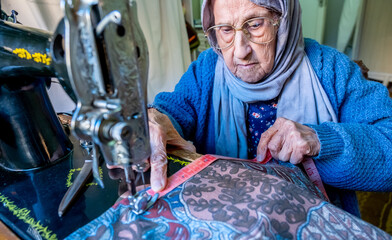 Arabic muslim woman sewing and measuring lengths with her tape