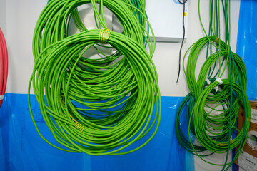 Coils of green network cable in building under construction