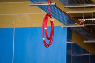 coil of computer network cable hanging from ceiling in building under construction