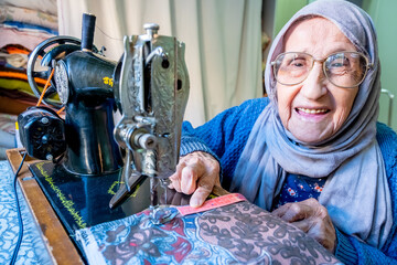 Arabic muslim woman sewing and measuring lengths with her tape