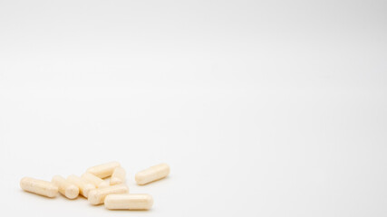 Medication in the form of capsules/pills/tablets against a white background