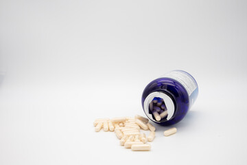 Medication in the form of capsules/pills/tablets against a white background