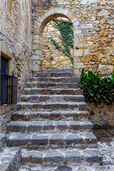 Fototapeta na wymiar Castle de Pals, a staircase leading through an arch to the center of the castle. Pals, Spain
