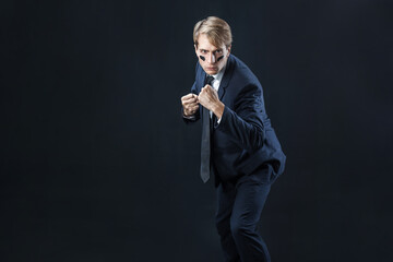 young man in a business suit rolled up his sleeves and Boxing. Aggressive business, concept.