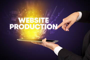 Close-up of a touchscreen with WEBSITE PRODUCTION inscription, innovative technology concept