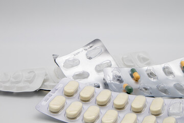 Medication in the form of capsules/pills/tablets against a white background