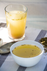 Bone broth. Collagen. The chicken broth in plate flat lay. Clear soup. bouillon with shadow.