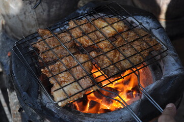 Roasted beef on charcoal grilled Isan Thai food that is bold and delicious.