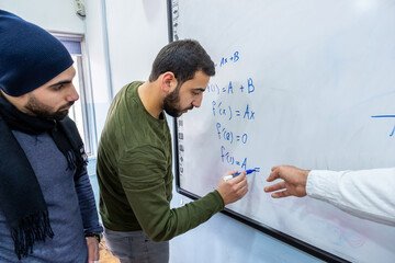 Teacher at university teaching his students how to solve mathmetics