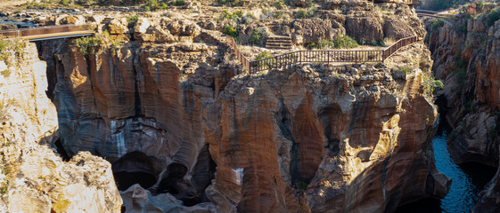 canyon with natural water potholes with clear mountain water and rocks out of focus with grain