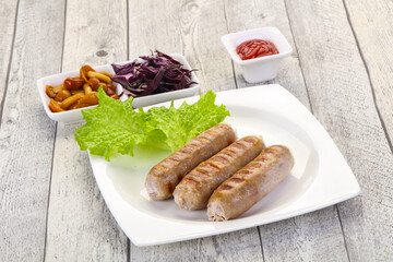 Grilled sausages served mushrooms and cabbage
