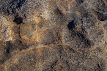 sandstone texture with wind and water erosion holes out of focus with grain