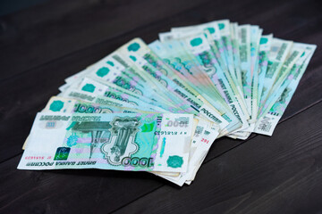 A bundle of Russian money on a wooden background