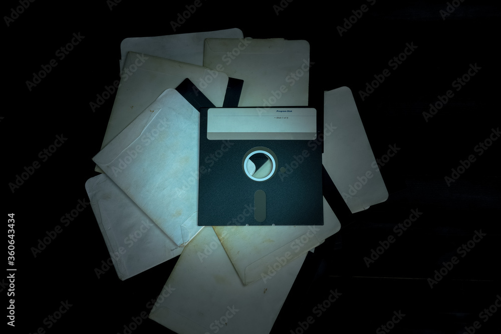 Wall mural vintage floppy disk 5.25 on a black background