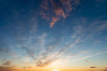 
evening blue sky at sunset the setting sun over the horizon