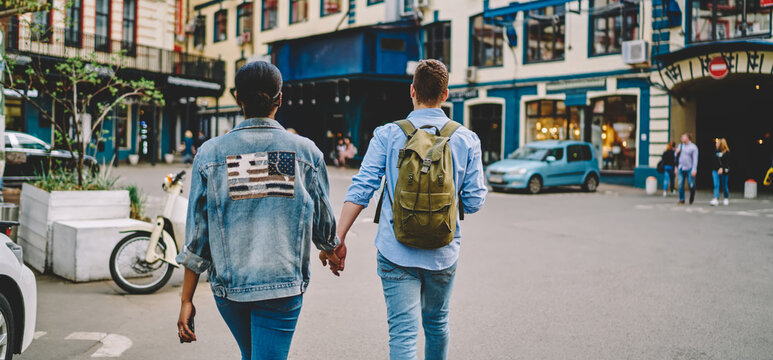 Back View Of Diverse Male And Female Travellers Dressed In Fashionable Denim Outfit Walking In Historic Center During Together Getaway Journey,good Looking Hipster Guys In Jeans Clothing Visiting Town
