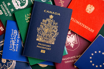 Composition from different passports of the world. In the center is a biometric passport of Canada.
