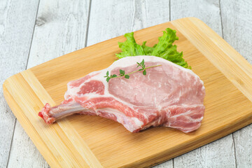 Raw pork bone steak over wooden