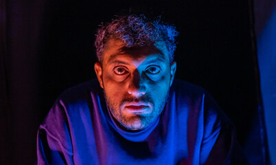 Muslim man with lights reflection on his face