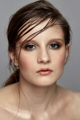 Naklejka premium Fashionable make-up on the face of a young brunette girl.
