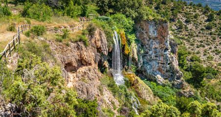 Hiking track over waterfall with blurred tourists