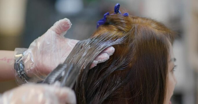 Woman dye her hair at salon