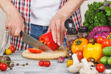Woman cooks at the kitchen, soft focus background
