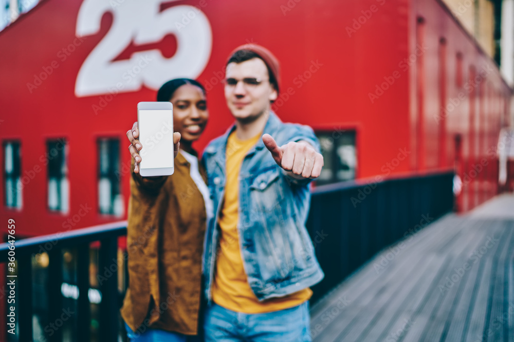 Aufkleber selective focus on modern smartphone with mock up screen, man showing thumb up gesture satisfied wit