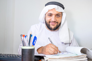 Arabic muslim man working on some paper