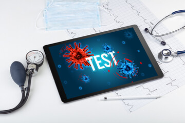 Tablet pc and doctor tools on white surface with TEST inscription, pandemic concept